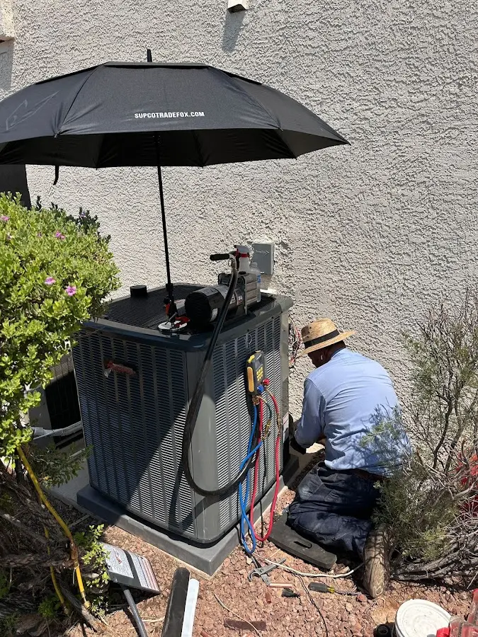 HVAC technician performing outdoor AC maintenance in Ontario