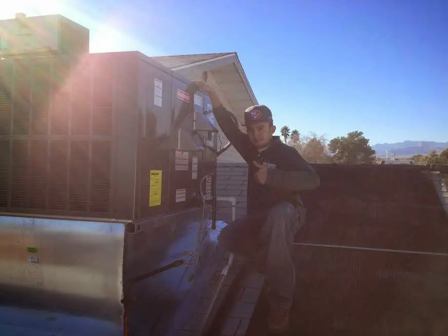 HVAC technician performing HVAC Inspection on a rooftop unit in Ontario